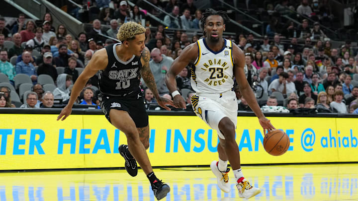 Mar 3, 2024; San Antonio, Texas, USA;  Indiana Pacers forward Aaron Nesmith (23) dribbles against San Antonio Spurs forward Jeremy Sochan (10) in the first half at Frost Bank Center. Mandatory Credit: Daniel Dunn-Imagn Images