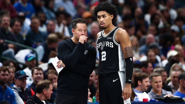 Oct 22, 2025; Dallas, Texas, USA; San Antonio Spurs coach Mitch Johnson speaks with guard Dylan Harper (2) during the game against the Dallas Mavericks at American Airlines Center.