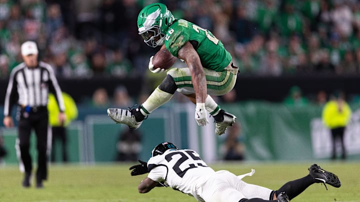 Nov 3, 2024; Philadelphia, Pennsylvania, USA; Philadelphia Eagles running back Saquon Barkley (26) leaps over Jacksonville Jaguars cornerback Ronald Darby (25) while running with the ball during the fourth quarter at Lincoln Financial Field. Mandatory Credit: Bill Streicher-Imagn Images Nov 3, 2024; Philadelphia, Pennsylvania, USA; Philadelphia Eagles running back Saquon Barkley (26) leaps over Jacksonville Jaguars cornerback Ronald Darby (25) while running with the ball during the fourth quarter at Lincoln Financial Field. Mandatory Credit: Bill Streicher-Imagn Images