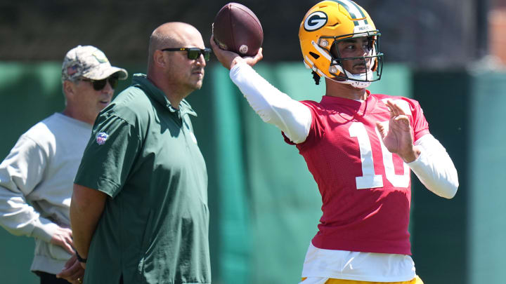 As Green Bay Packers offensive coordinator Adam Stenavich looks on, quarterback Jordan Love (10) throws a pass during organized team activities Wednesday, May 29, 2024 in Green Bay, Wisconsin.