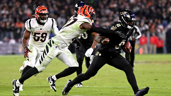 Nov 16, 2023; Baltimore, Maryland, USA; Cincinnati Bengals safety Jordan Battle (27) tackles Baltimore Ravens quarterback Lamar Jackson (8) during the fourth quarter at M&T Bank Stadium. Mandatory Credit: Tommy Gilligan-Imagn Images