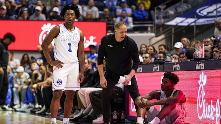 Jan 14, 2026; Provo, Utah, USA; BYU Cougars head coach Kevin Young speaks to BYU Cougars guard Robert Wright III (1)  and forward Kennard Davis Jr. (30) in the second half against the TCU Horned Frogs  at Marriott Center. Mandatory Credit: Aaron Baker-Imagn Images
