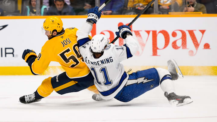 Nov 29, 2024; Nashville, Tennessee, USA;  Nashville Predators defenseman Roman Josi (59) and Tampa Bay Lightning center Luke Glendening (11) collide during the first period at Bridgestone Arena. Mandatory Credit: Steve Roberts-Imagn Images