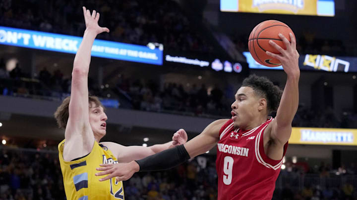 Wisconsin guard John Tonje (9) goes up against Marquette forward Ben Gold (12) during the second half of their game Saturday, Dec. 7, 2024, at Fiserv Forum in Milwaukee, Wisconsin. Marquette beat Wisconsin 88-74. Wisconsin guard John Tonje (9) goes up against Marquette forward Ben Gold (12) during the second half of their game Saturday, Dec. 7, 2024, at Fiserv Forum in Milwaukee, Wisconsin. Marquette beat Wisconsin 88-74.