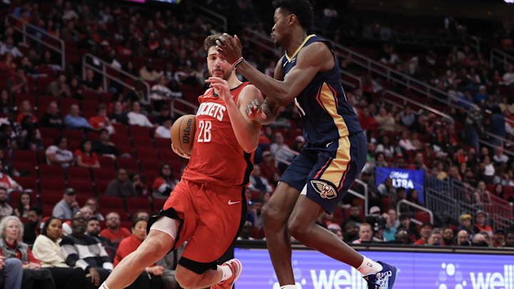 Dec 19, 2024; Houston, Texas, USA;  Houston Rockets center Alperen Sengun (28) drives to the net against New Orleans Pelicans center Yves Missi (21) in the second half at Toyota Center. Mandatory Credit: Thomas Shea-Imagn Images