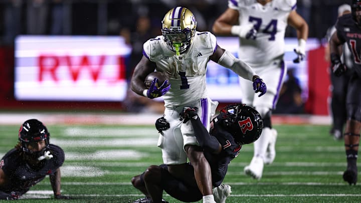 Sep 27, 2024; Piscataway, New Jersey, USA; Washington Huskies running back Jonah Coleman (1) is tackled by Rutgers Scarlet Knights defensive back Robert Longerbeam (7) during the first half at SHI Stadium. Mandatory Credit: Vincent Carchietta-Imagn Images