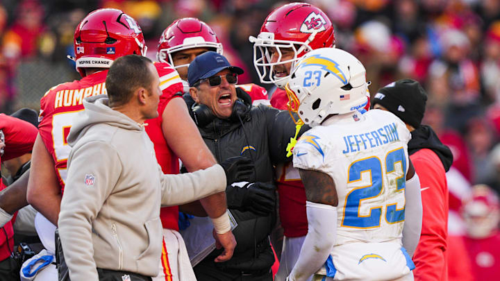 Los Angeles Chargers head coach Jim Harbaugh breaks up a confrontation between safety Tony Jefferson and the Kansas City Chiefs during the fourth quarter at Arrowhead Stadium.