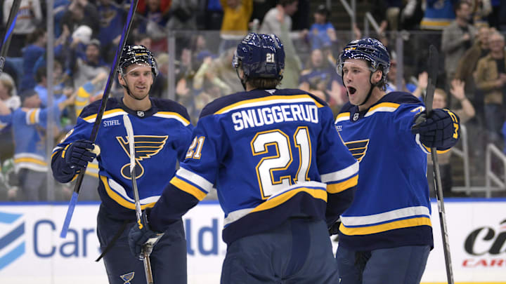 Oct 18, 2025; St. Louis, Missouri, USA; St. Louis Blues right wing Jimmy Snuggerud (21) is congratulated by left wing Pavel Buchnevich (89) and defenseman Tyler Tucker (75) after scoring against the Dallas Stars during the second period at Enterprise Center. Mandatory Credit: Jeff Le-Imagn Images Oct 18, 2025; St. Louis, Missouri, USA; St. Louis Blues right wing Jimmy Snuggerud (21) is congratulated by left wing Pavel Buchnevich (89) and defenseman Tyler Tucker (75) after scoring against the Dallas Stars during the second period at Enterprise Center. Mandatory Credit: Jeff Le-Imagn Images