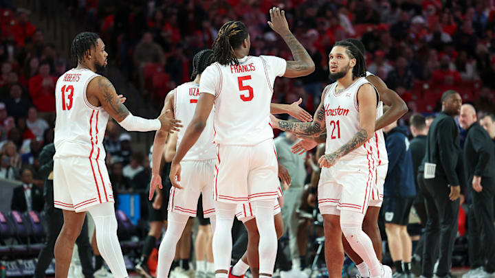 Houston guard Emanuel Sharp (21) congratulated by teammates