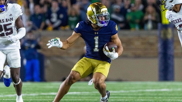 Sep 13, 2025; South Bend, Indiana, USA; Notre Dame Fighting Irish wide receiver Jaden Greathouse (1) runs with the ball during the second half against the Texas A&M Aggies at Notre Dame Stadium. Mandatory Credit: Michael Caterina-Imagn Images