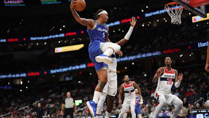 Nov 1, 2025; Washington, District of Columbia, USA; Orlando Magic forward Paolo Banchero (5) leaps to pass the ball as Washington Wizards guard Bilal Coulibaly (0) defends in the first half at Capital One Arena. Mandatory Credit: Geoff Burke-Imagn Images