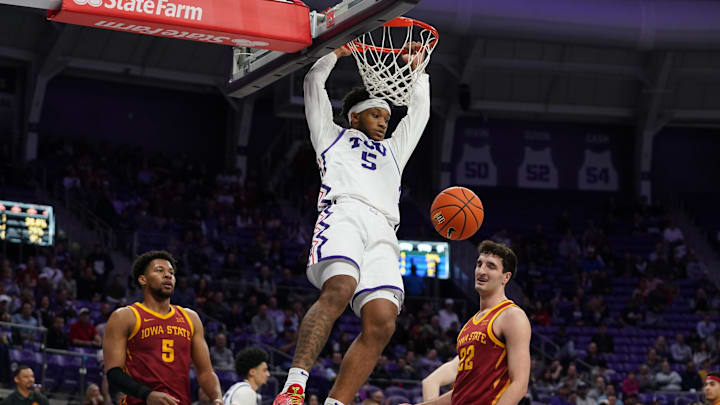 Feb 10, 2026; Fort Worth, Texas, USA;  TCU Horned Frogs forward Micah Robinson (5) follows through on a dunk as Iowa State Cyclones forward Joshua Jefferson (5) and forward Milan Momcilovic (22) look on during the first half at Ed and Rae Schollmaier Arena. Mandatory Credit: Raymond Carlin III-Imagn Images