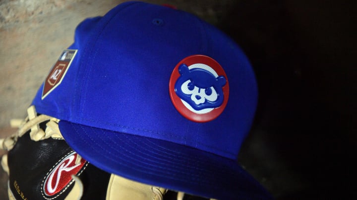 Mar 24, 2018; Peoria, AZ, USA; A Chicago Cubs cap sits on the dugout steps during the second inning of the game against the Seattle Mariners at Peoria Sports Complex. 