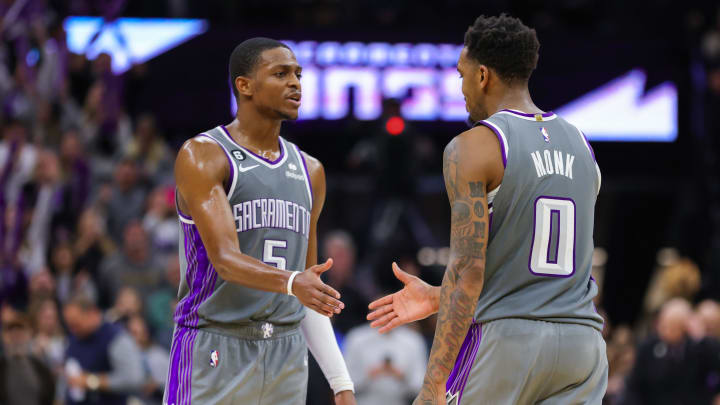 Dec 28, 2022; Sacramento, California, USA; Sacramento Kings guard De'Aaron Fox (5) congratulates guard Malik Monk (0) during the fourth quarter against the Denver Nuggets at Golden 1 Center. Mandatory Credit: Sergio Estrada-USA TODAY Sports