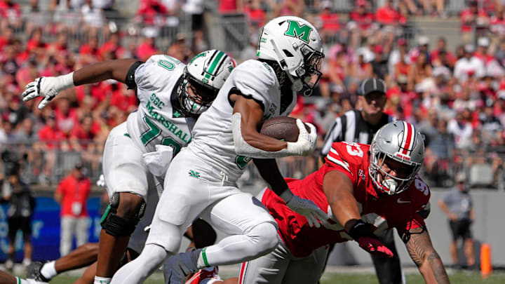 Marshall Thundering Herd running back A.J. Turner (5) is pursued by Ohio State Buckeyes defensive tackle Hero Kanu (93) during the first half of an NCAA Division I football game at Ohio Stadium on Saturday.