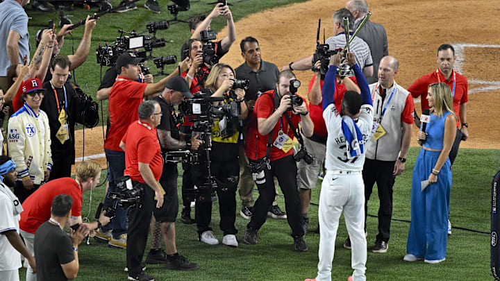 Jul 15, 2024; Arlington, TX, USA; National League outfielder Teoscar Hernandez of the Los Angeles Dodgers (37) raises the trophy as he celebrates after he wins the 2024 All Star Game Home Run Derby at Globe Life Field. Mandatory Credit: Jerome Miron-Imagn Images