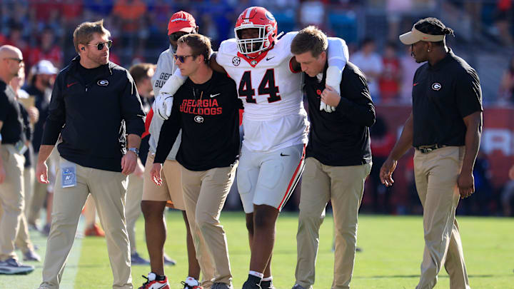 defensive lineman Jordan Hall (44) is helped off the field during the first quarter of an NCAA football game, Saturday, Nov. 1, 2025, at EverBank Stadium in Jacksonville, Fla. [Corey Perrine/Florida Times-Union]