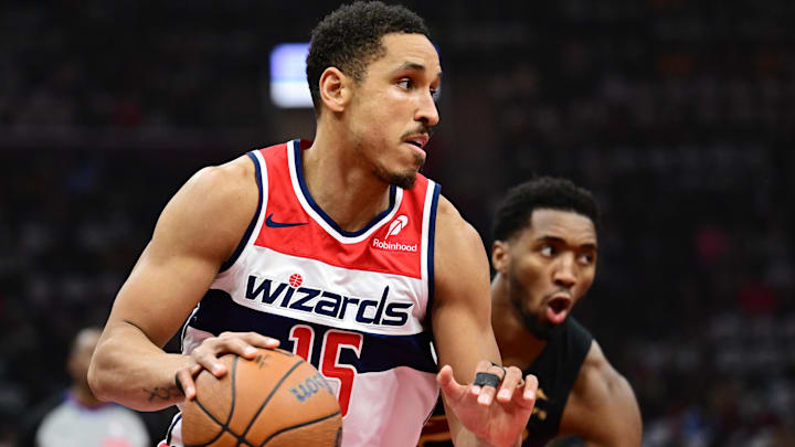 Dec 3, 2024; Cleveland, Ohio, USA; Washington Wizards guard Malcolm Brogdon (15) drives to the basket against Cleveland Cavaliers guard Donovan Mitchell (45) during the first quarter at Rocket Mortgage FieldHouse. Mandatory Credit: Ken Blaze-Imagn Images