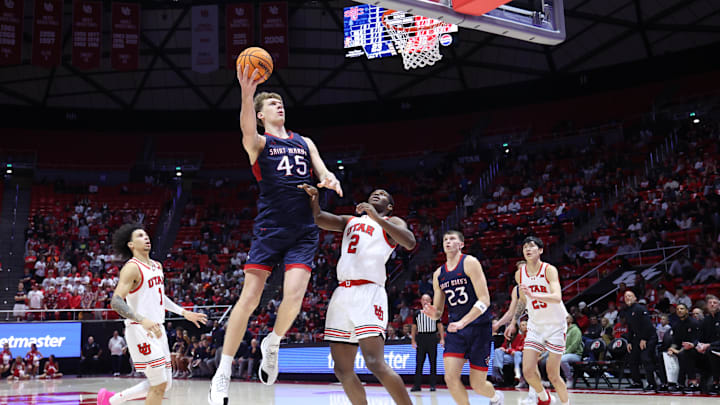 Dec 7, 2024; Salt Lake City, Utah, USA; St. Mary's Gaels center Andrew McKeever (45) drives to the basket against Utah Utes forward Ezra Ausar (2) during the first half at Jon M. Huntsman Center. Mandatory Credit: Rob Gray-Imagn Images