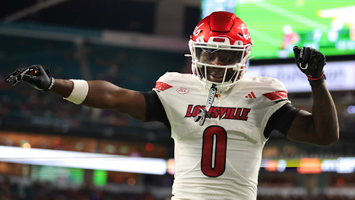 Oct 17, 2025; Miami Gardens, Florida, USA; Louisville Cardinals wide receiver Chris Bell (0) celebrates after scoring a touchdown against the Miami Hurricanes during the first quarter at Hard Rock Stadium. Mandatory Credit: Sam Navarro-Imagn Images
