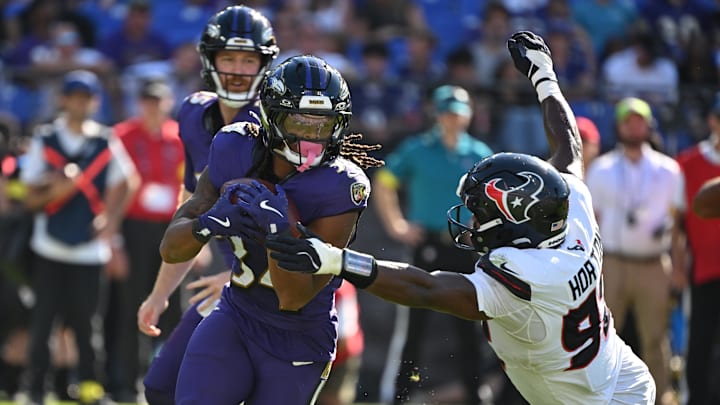 Oct 5, 2025; Baltimore, Maryland, USA; Baltimore Ravens running back Keaton Mitchell (34) runs for a gain past Houston Texans defensive end Dylan Horton (92) during the fourth quarter at M&T Bank Stadium. Mandatory Credit: Rafael Suanes-Imagn Images Oct 5, 2025; Baltimore, Maryland, USA; Baltimore Ravens running back Keaton Mitchell (34) runs for a gain past Houston Texans defensive end Dylan Horton (92) during the fourth quarter at M&T Bank Stadium. Mandatory Credit: Rafael Suanes-Imagn Images