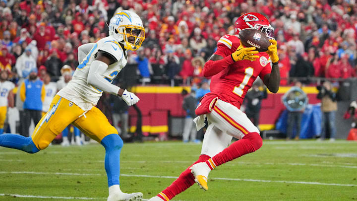 Dec 8, 2024; Kansas City, Missouri, USA; Kansas City Chiefs wide receiver Xavier Worthy (1) runs the ball as Los Angeles Chargers cornerback Cam Hart (20) defends during the first half at GEHA Field at Arrowhead Stadium. Mandatory Credit: Denny Medley-Imagn Images
