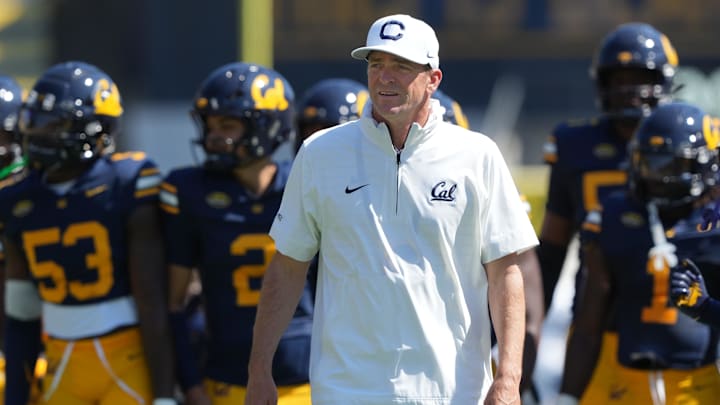 Sep 6, 2025; Berkeley, California, USA; California Golden Bears head coach Justin Wilcox (center) walks on the field before the game against the Texas Southern Tigers at California Memorial Stadium. Mandatory Credit: Darren Yamashita-Imagn Images