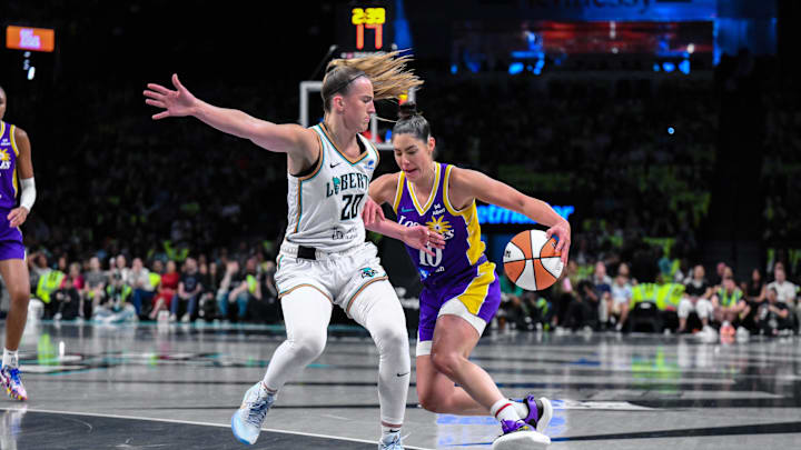 Jul 26, 2025; Brooklyn, New York, USA; Los Angeles Sparks guard Kelsey Plum (10) drives to the basket as New York Liberty guard Sabrina Ionescu (20) defends during the first half at Barclays Center. Mandatory Credit: John Jones-Imagn Images