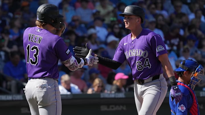 Feb 25, 2026; Mesa, Arizona, USA; Colorado Rockies first baseman T.J. Rumfield (64) celebrates with left fielder Zac Veen after hitting a solo home run against the Chicago Cubs in the second inning at Sloan Park. Mandatory Credit: Rick Scuteri-Imagn Images Feb 25, 2026; Mesa, Arizona, USA; Colorado Rockies first baseman T.J. Rumfield (64) celebrates with left fielder Zac Veen after hitting a solo home run against the Chicago Cubs in the second inning at Sloan Park. Mandatory Credit: Rick Scuteri-Imagn Images