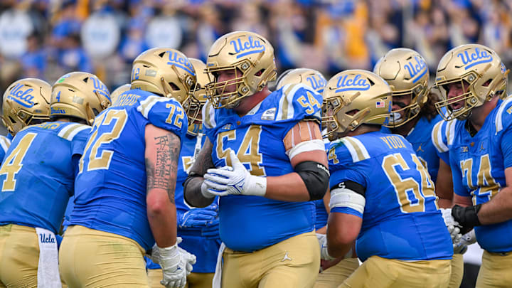 Nov 30, 2024; Pasadena, California, USA; UCLA Bruins offensive lineman Josh Carlin (54) in the huddle during the second quarter against the Fresno State Bulldogs at Rose Bowl. Mandatory Credit: Robert Hanashiro-Imagn Images