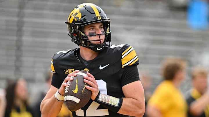 Sep 14, 2024; Iowa City, Iowa, USA; Iowa Hawkeyes quarterback Cade McNamara (12) warms up before the game against the Troy Trojans at Kinnick Stadium.