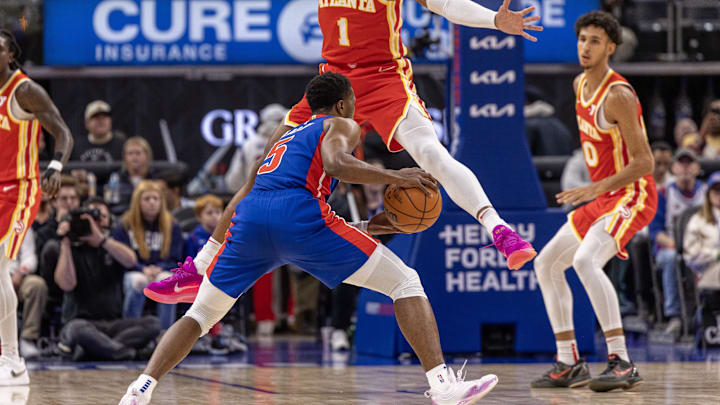 Nov 8, 2024; Detroit, Michigan, USA; Detroit Pistons guard Malik Beasley (5) fakes a shot attempt on Atlanta Hawks forward Jalen Johnson (1) during the first half at Little Caesars Arena. Mandatory Credit: David Reginek-Imagn Images