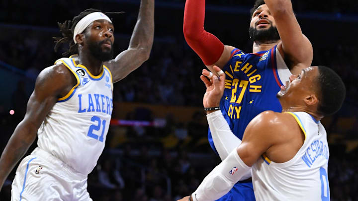 Oct 30, 2022; Los Angeles, California, USA;  Denver Nuggets guard Jamal Murray (27) is defended by Los Angeles Lakers guard Patrick Beverley (21) and guard Russell Westbrook (0) in the first half at Crypto.com Arena. Mandatory Credit: Jayne Kamin-Oncea-Imagn Images