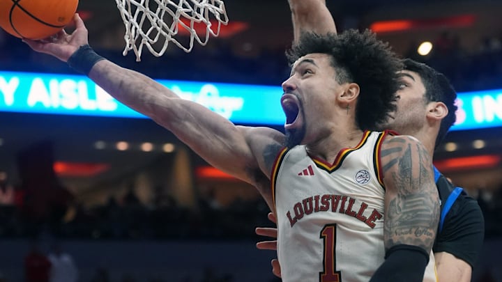 Louisville Cardinals guard J'vonne Hadley (1) tries to make the basket against Southern Methodist University Mustangs center Samet Yigitoglu (24) Saturday at the KFC Yum! Center.
Jan. 31, 2026