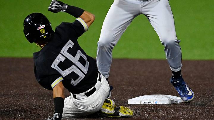 Oregon's Rikuu Nishida (56) steals second base ahead of the tag by Xavier second baseman Jared Cushing (32) in the first inning of an NCAA college baseball tournament regional championship game Sunday, June 4, 2023, in Nashville, Tenn.
