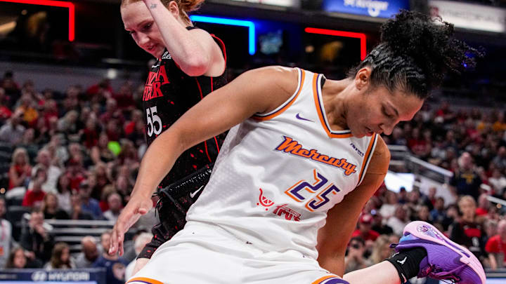 Indiana Fever forward Chloe Bibby (55) loses the ball against Phoenix Mercury forward Alyssa Thomas (25) on Wednesday, July 30, 2025, during the game at Gainbridge Fieldhouse in Indianapolis.