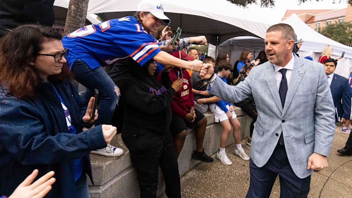 Florida Gators head coach Billy Napier gives fist bumps to fans during Gator Walk at Ben Hill Griffin Stadium in Gainesville, FL on Saturday, November 25, 2023 befoe the game against the Florida State Seminoles. [Doug Engle/Gainesville Sun]