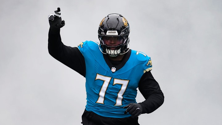 Jacksonville Jaguars offensive tackle Anton Harrison (77) runs on the field before an NFL football matchup at EverBank Stadium, Sunday, Jan. 4, 2026, in Jacksonville, Fla. The Jaguars defeated the Titans 41-7, capturing the AFC South title. [Corey Perrine/Florida Times-Union]