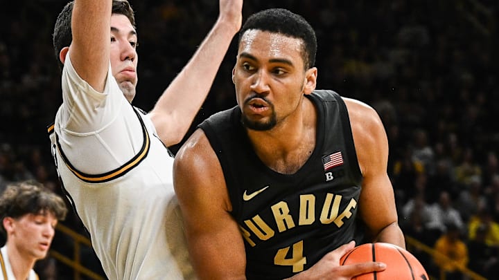Purdue Boilermakers forward Trey Kaufman-Renn (4) controls the ball as Iowa Hawkeyes forward Alvaro Folgueiras (7) defends.