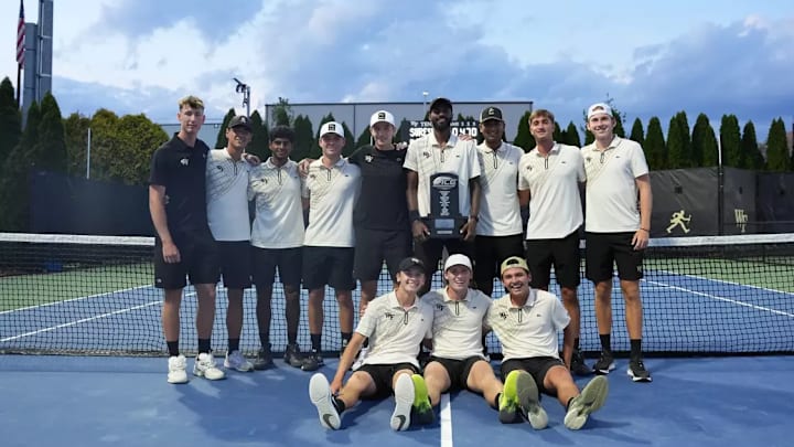 Wake Forest men's tennis team celebrates with trophy after winning ACC regular season title 