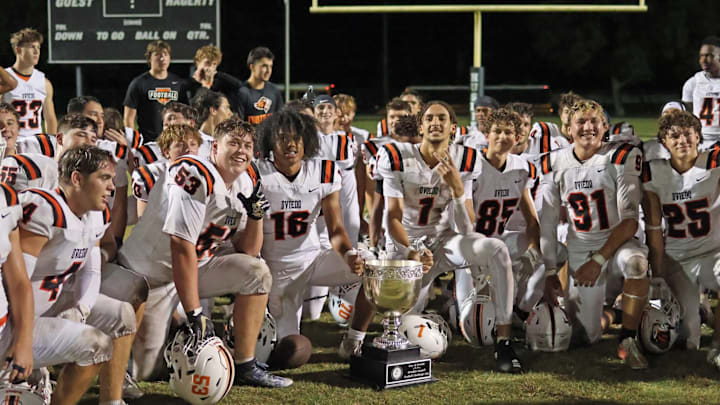Oviedo High's football team celebrates after beating crosstown rival Hagerty, 42-28, last year to win Oviedo's annual Football Challenge Cup. The Lions play a competitive schedule again in 2025.
