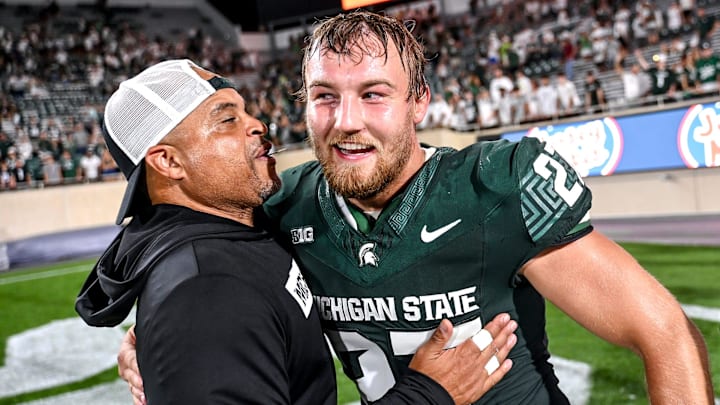 Michigan State's Cal Haladay, right, celebrates with defensive backs coach Demetrice Martin after the Spartans win over Florida Atlantic on Friday, Aug. 30, 2024, at Spartan Stadium in East Lansing.