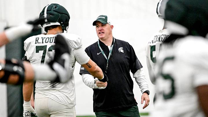 Michigan State's head coach Pat Fitzgerald, right, talks with Rustin Young during spring football practice on Tuesday, April 14, 2026, in East Lansing. Michigan State's head coach Pat Fitzgerald, right, talks with Rustin Young during spring football practice on Tuesday, April 14, 2026, in East Lansing.