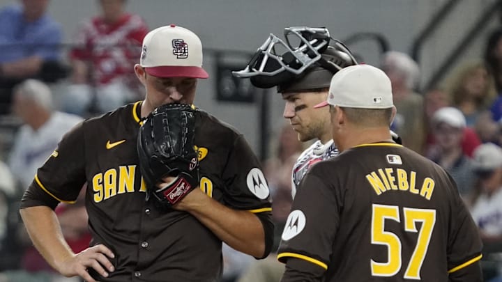 San Diego Padres pitcher Michael King (34) is visited on the mound by pitching coach Ruben Niebla (57) during the sixth inning against the Texas Rangers at Globe Life Field on July 4, 2024.