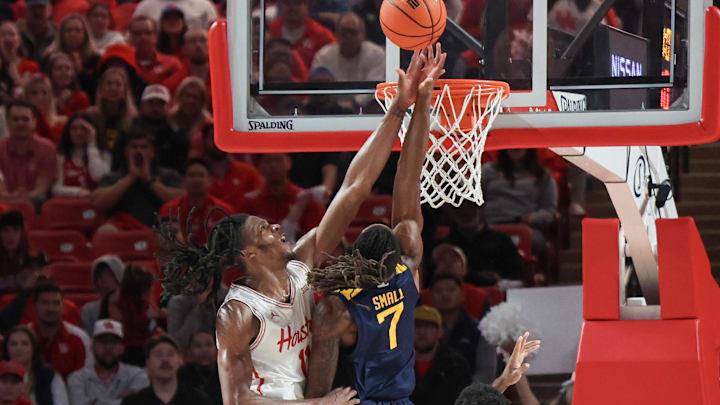 Jan 15, 2025; Houston, Texas, USA; Houston Cougars forward Joseph Tugler (11) blocks West Virginia Mountaineers guard Javon Small (7) shot in the first half at Fertitta Center. Jan 15, 2025; Houston, Texas, USA; Houston Cougars forward Joseph Tugler (11) blocks West Virginia Mountaineers guard Javon Small (7) shot in the first half at Fertitta Center.