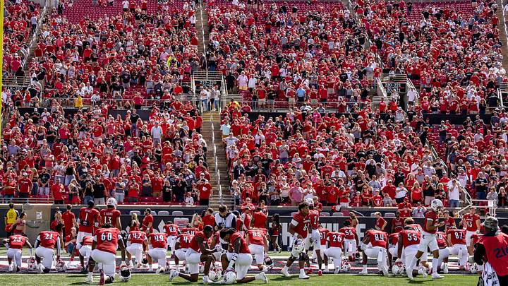 The Louisville football team prays in front of The Crunch Zone The Louisville football team prays in front of The Crunch Zone