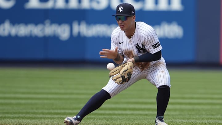Jul 13, 2025; Bronx, New York, USA; New York Yankees shortstop Anthony Volpe (11) fields a ground ball hit by Chicago Cubs third baseman Matt Shaw (6) (not pictured) during the eighth inning at Yankee Stadium. Mandatory Credit: Gregory Fisher-Imagn Images