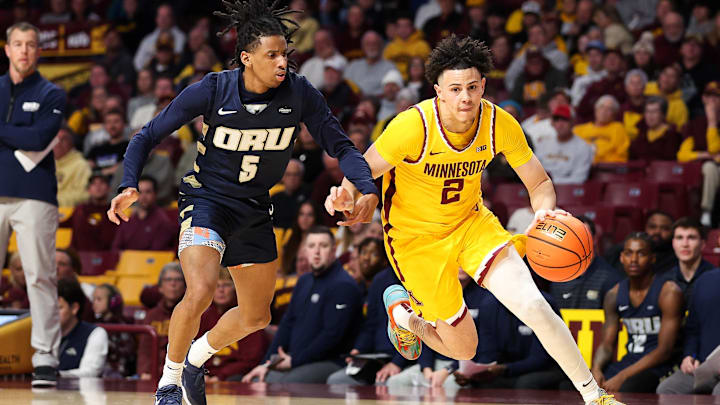 Nov 6, 2024; Minneapolis, Minnesota, USA; Minnesota Golden Gophers guard Mike Mitchell Jr. (2) works around Oral Roberts Golden Eagles guard Darius Robinson Jr. (5) during the first half at Williams Arena. Mandatory Credit: Matt Krohn-Imagn Images