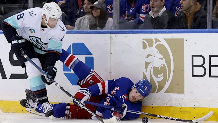 Jan 16, 2024; New York, New York, USA; New York Rangers left wing Alexis Lafreniere (13) and Seattle Kraken defenseman Brian Dumoulin (8) fight for the puck during the third period at Madison Square Garden. Mandatory Credit: Brad Penner-Imagn Images