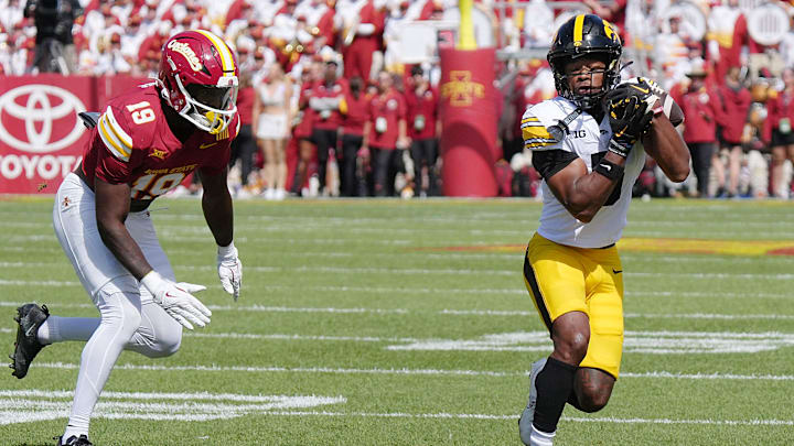 Iowa Hawkeyes wide receiver Jacob Gill (5) catches a pass around Iowa State Cyclones' defensive back Ta’Shawn James (19) during the first quarter in the Cy-Hawk Series at Jack Trice Stadium on Sept. 6, 2025, in Ames, Iowa.